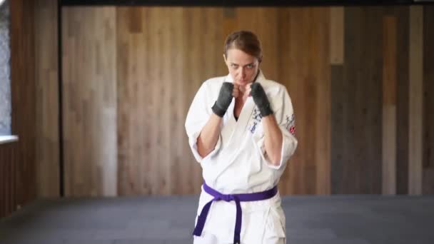 Portrait Sportswoman Kimono Facing Camera Moving Aggressively Ready Fight Female — Stockvideo