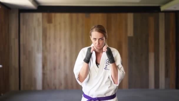 Portrait Sportswoman Kimono Facing Camera Moving Aggressively Ready Fight Female — Stockvideo