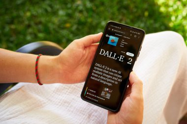 February 5, 2023, Mirissa, Sri Lanka. Using OpenAI DALL-E on phone. Woman testing artificial intelligence image generator. Person creating pictures via neural network online close-up. Human vs AI