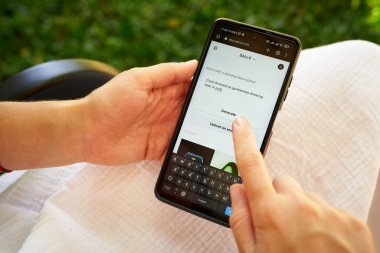 February 5, 2023, Mirissa, Sri Lanka. Using OpenAI DALL-E on phone. Woman testing artificial intelligence image generator. Person creating pictures via neural network online close-up. Human vs AI