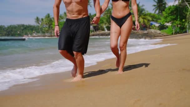 Legs Biracial Couple Swimsuits Holding Hands Running Ocean Tide Waves — Stock videók