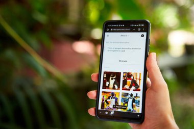 February 5, 2023, Mirissa, Sri Lanka. Using OpenAI DALL-E on phone. Woman testing artificial intelligence image generator. Person creating pictures via neural network online close-up. Human vs AI