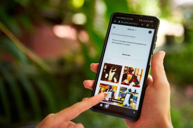 February 5, 2023, Mirissa, Sri Lanka. Using OpenAI DALL-E on phone. Woman testing artificial intelligence image generator. Person creating pictures via neural network online close-up. Human vs AI