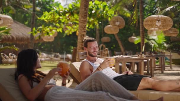 Young Happy Multiethnic Couple Relaxing Sunbeds Tropical Resort Clink Drink — Stock Video