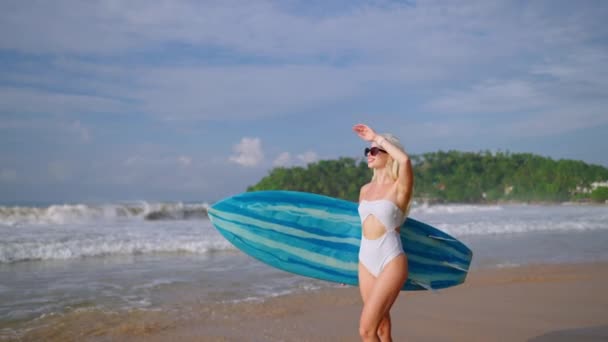 Young Blonde Woman Surfer Bikini Holding Surfboard Walking Ocean Tropical — Stock video