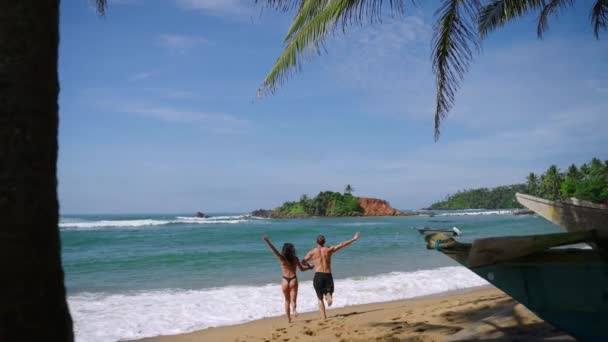 Young Cheerful Biracial Couple Swimsuits Holding Hands Running Ocean Splashing — Vídeo de stock
