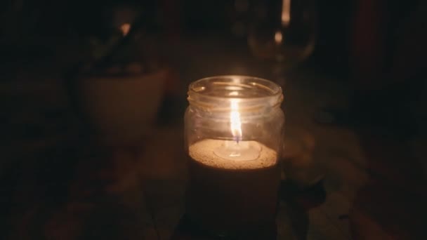 Burning Candle Glass Jar Wooden Table Darkness Soothing Cozy Video — Stock Video