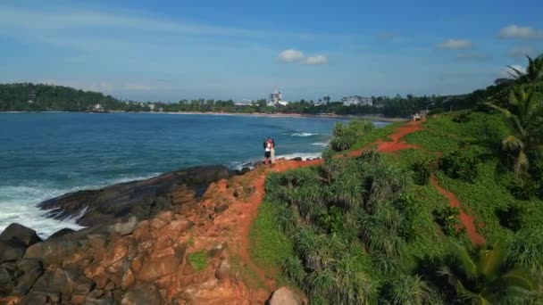 Young Couple Stands Top Green Tropical Rocky Island Middle Sea — Stock Video