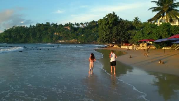 Young Multiracial Couple Runs Tropical Beach Tide Ocean Sunrise Back — Stock Video