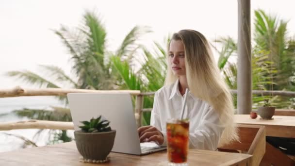 Okyanus Manzaralı Palmiye Ağaçları Olan Bir Kafede Dizüstü Bilgisayarla Çalışan — Stok video