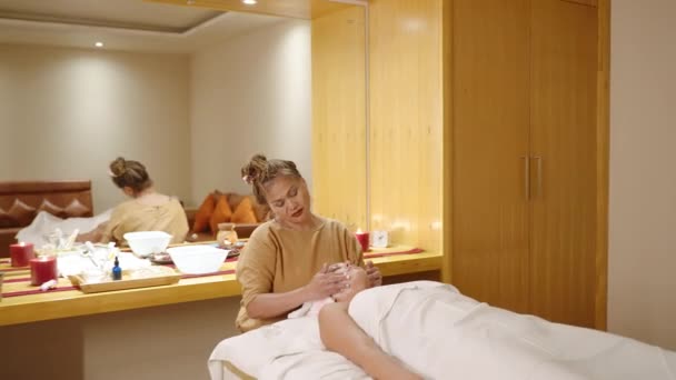 Young White Woman Gets Facial Massage Spa Senior Biethnic Female — Stock Video