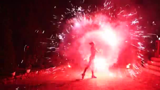 火势表演 红色的火花在夜晚 女艺术家在街上旋转着燃烧着的工作人员 消防队员在节日期间表演了令人惊叹的消防艺术 用烟火作秀的年轻女人 — 图库视频影像