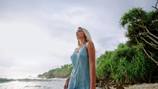 Bronzed Γυναίκα Βόλτες Κατά Μήκος Της Ακτογραμμής Κομψό Μπλε Φόρεμα — Αρχείο Βίντεο