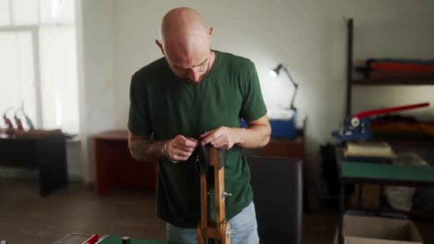 Professional Leather Craftsman Stands Work Table Sews Black Handbag Pressed — Stock Video