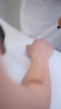 Cilt bakımı uzmanları klinikte saç temizleme tedavisi için hazırlanıyor. Estetikçi, lazer epilasyonundan önce müşterilerine ön kol soğutma jeli uygular. Cerrahi olmayan, pürüzsüz deri prosedürü adım adım kaydedildi..