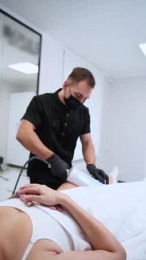 Terapist, selülit azaltımı için cihaz kullanarak hastaların bacaklarına sonosferler terapi masajı yapıyor, deri sıkma klinik ortamında dolaşımı artırıyor..