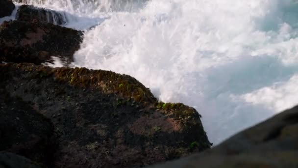 海水在大海中喷涌 沿海风景在自然光中飘扬 汹涌的海浪涌过崎岖的海岸线岩石 多姿多彩的海景在阳光灿烂的日子里捕捉大自然的力量 — 图库视频影像