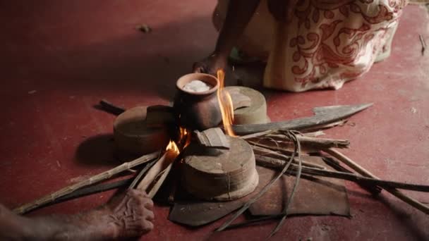 Hands Tend Clay Pot Wood Fire Symbolizing Prosperity Buddhist Celebration — Stock Video