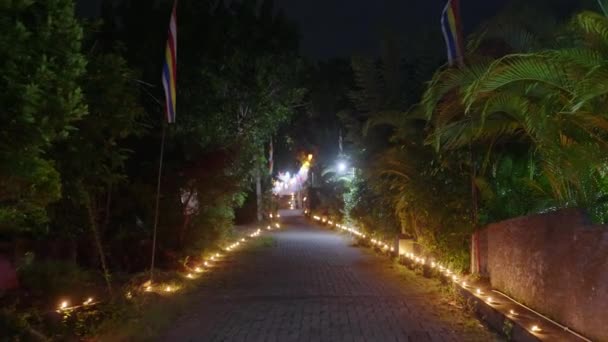 Pathway Lined Glowing Candles Oil Lamps Buddhist Temple Night Illuminated — Stock Video
