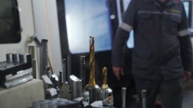 2021-09-23 - Mariupol, Ukrane. Magma fabrikası. Uzman, değirmen araçlarını ayarlar, doğru altı taraflı mekanizmayı sağlar. İşçi CNC torna hassas araç karmaşık metal iş için takas.