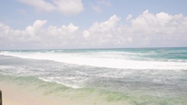 Doğada rahatlık, özgürlük, seyahat yaşam tarzı. Kadınlar turkuaz denizde sallanmayı, güneşli tropik plaj ortamlarını severler. Rahatlama hissi, tatil macerası, sahilde neşeli yalnız gezgin. Yavaş çekim.