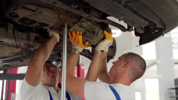 Car Repair Teamwork Undercar Service Procedure Auto Mechanics Work Vehicle — Stock Video