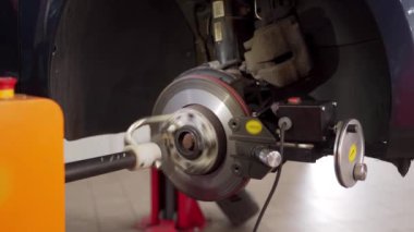 Araç bakımı, daha iyi performans ve güvenlik için disk yüzeyi. Otomotiv teknisyeni araba fren diski torna makinesini çalıştırıyor..