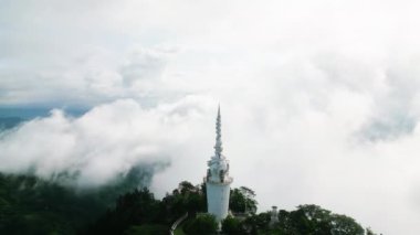 Hava aracı Ambuluwawa Kulesi 'nin Sri Lanka dağlarındaki delici sisi, çok inançlı sembolü doğal güzellikle uyumlu hale getiriyor. Yeşil manzara, kutsal bir yerde huzurlu bir atmosfer yaratıyor..