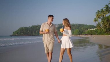 Mutlu çift okyanus sahilinde yürür, hindistan cevizi suyu içer. Genç kadın, erkek el ele tutuşur, yürürken konuşur. Romantik yeni evliler alkollü kokteyl yudumlar, gün doğumunda tropik deniz kıyısında balayı tatilinin tadını çıkarırlar..