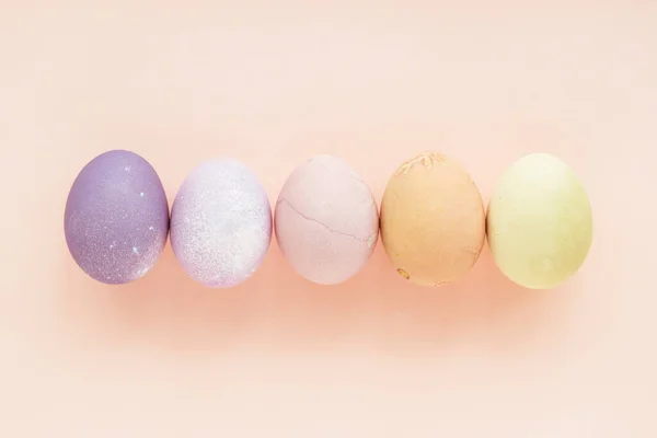 Pastel Colored Easter Eggs Peach Background Top View 图库照片