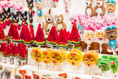 Varşova, Polonya - 6 Ocak 2023.Değişik şekil ve renklerde lolipoplar, bazı heykelciklerle birlikte bir pazar tezgahında cazip bir şekilde sergilenmektedir.