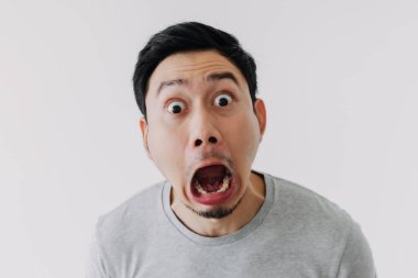Funny shocked surprised closeup asian face man isolated on white background.