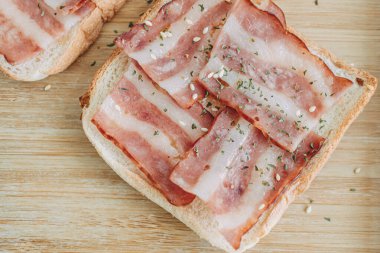 Easy and simple breakfast set of Bacon Sandwich served with black coffee on bed.