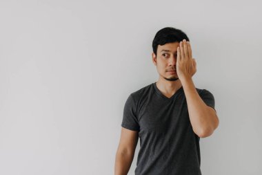 Asian man hand cover one eye isolated on white background for advertising space.
