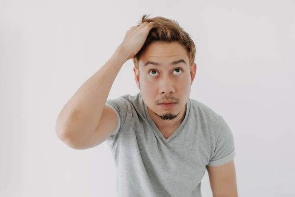 Asian Man Grey Shirt Looking His Dyed Hair Doubtfully Isolated — Stock Photo, Image