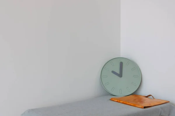 Document and clock on the table with empty space. Concept of work and time.