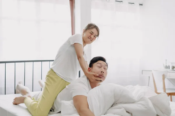 Funny Asian Couple Wife Giving Husband Hurt Massage White Bedroom — Stock Photo, Image