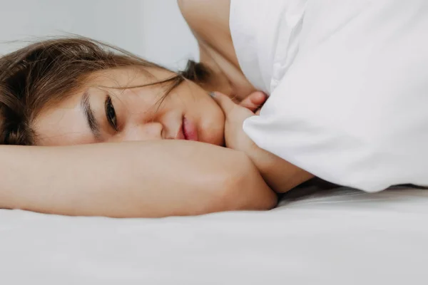 Asian woman sleeping and wake up late in very comfort morning.