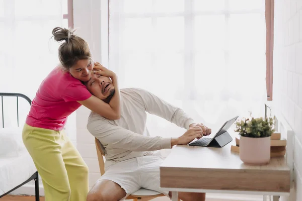 stock image Asian wife pulling husband out of the desk to stop working. Funny couple fight.