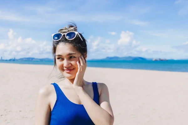 stock image Happy smile asian woman in blue dress walking on the sunny beach of Pattaya.