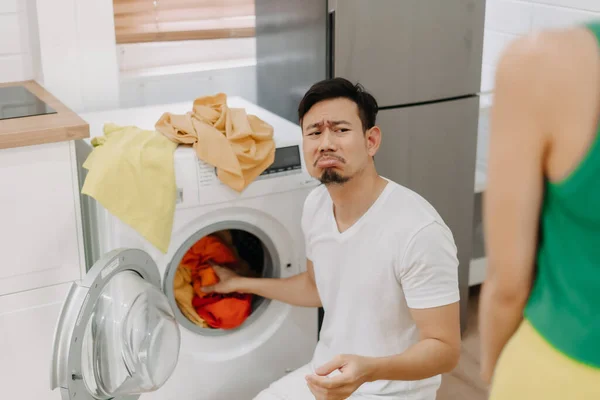 Funny crying face reaction of asian husband being forced to wash clothes by wife