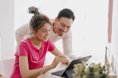 Asyalı karı koca online reklam hakkında tartışıyor ve planlıyorlar.