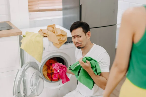 Funny crying face reaction of asian husband being forced to wash clothes by wife