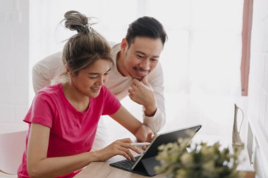 Asyalı karı koca online reklam hakkında tartışıyor ve planlıyorlar.