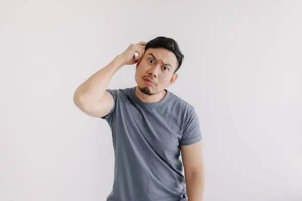 stock image Confused face of asian man in blue t-shirt stand isolated on white.