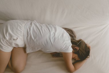 Asyalı kadın yorgun ve hastayken kanepede uyuyakalıyor..