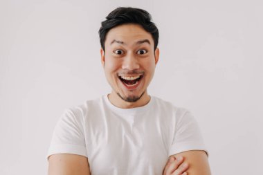 Asyalı adamın mutlu, gülen yüzü beyaz arka planda izole edilmiş beyaz tişört giyiyor..