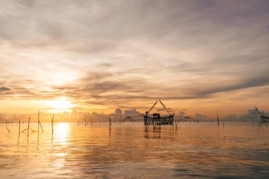 Morning scene of villager fish net in Songkhla lake, Phatthalung, Thailand. clipart