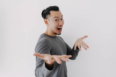 Gri yün katmanlı Asyalı adam beyazdan sunar..