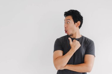 Taylandlı erkek model başını çeviriyor ve kapalı alanda sorgulama ifadesiyle işaret ediyor